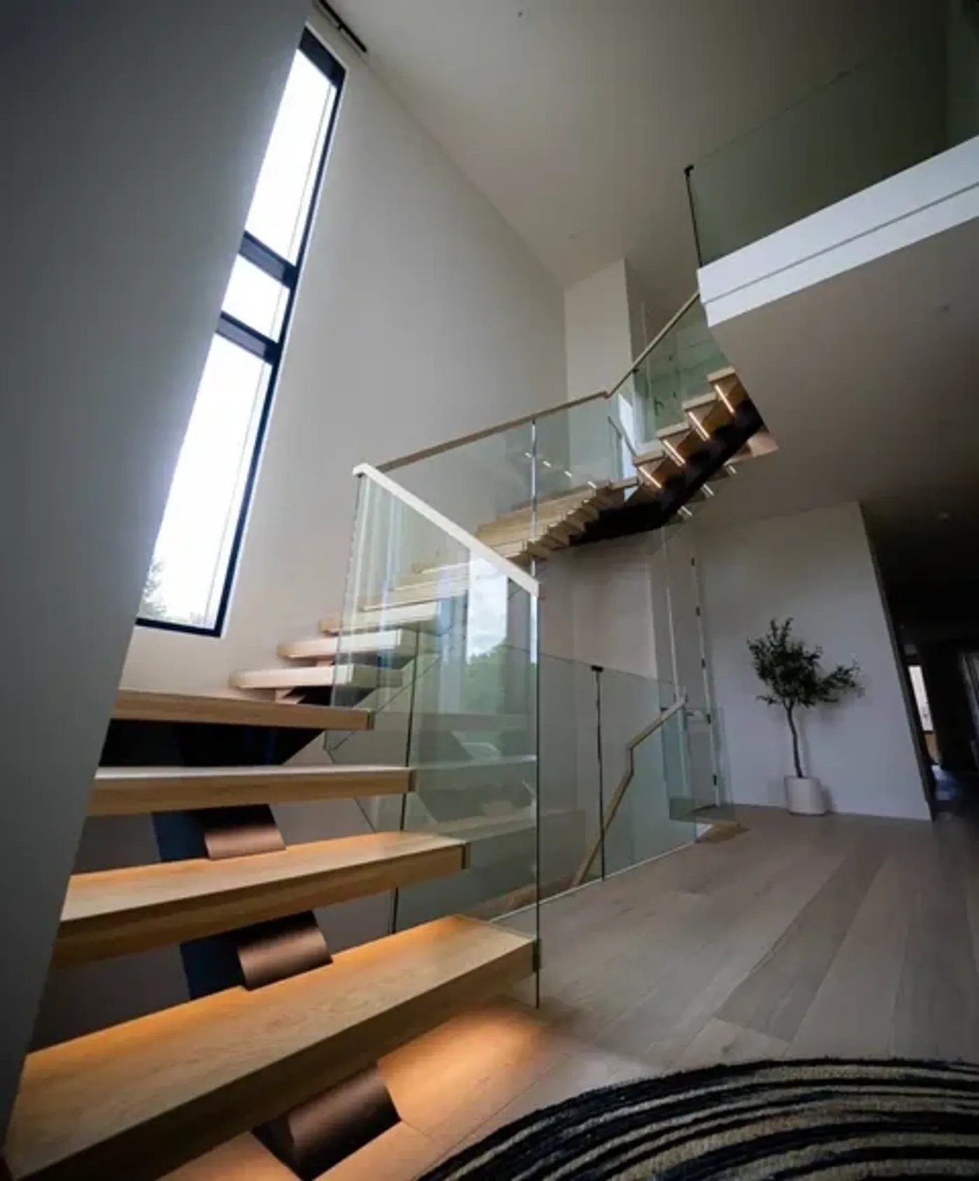 Custom glass balustrade railing system on a floating staircase in NYC